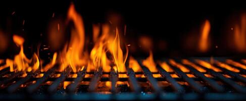 The mesmerizing flames dancing on a barbecue grill in the dark. photo