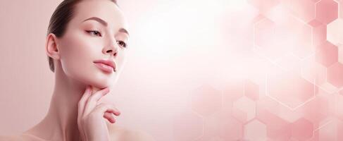 The elegant woman showcasing beauty and radiance in a soft pink background. photo