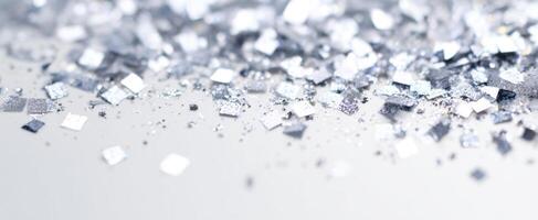 The shimmering silver glitter scattered on a surface for artistic decor. photo