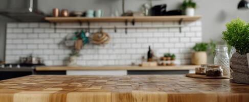 The wooden countertop in a modern kitchen with decorative elements and greenery. photo