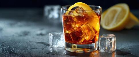 The refreshing whiskey cocktail with ice and a lemon slice garnishing. photo