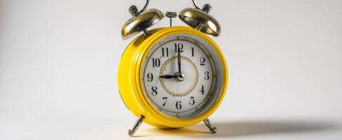 The vintage yellow alarm clock symbolizing the importance of time management. photo