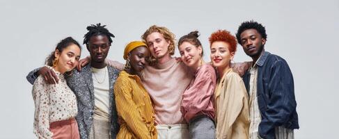 The diverse group of friends joyfully posing together in a modern studio setting. photo