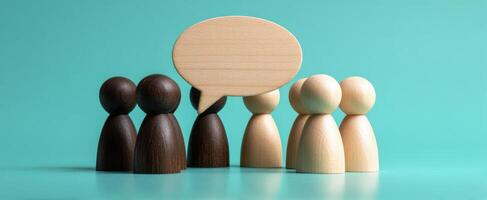 The wooden figurines engaged in a lively conversation through a speech bubble. photo