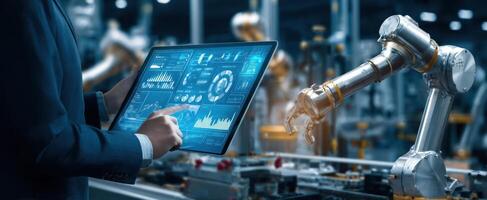 The robotic arm interacting with a touchscreen tablet in a modern factory environment. photo