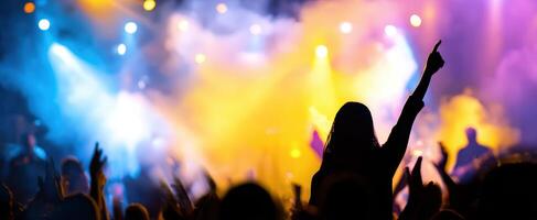 The vibrant atmosphere of a concert with silhouettes and colorful lights. photo