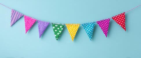 The Colorful Bunting Flags Creating a Joyful Party Atmosphere on a Blue Background photo