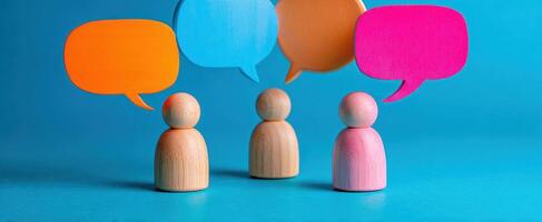 The wooden figures engaged in colorful conversations with speech bubbles. photo