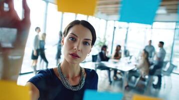 The focused woman collaborating in a modern office environment with creative ideas. photo