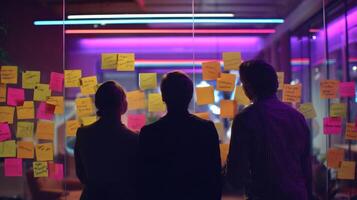 The professionals collaborating in a vibrant workspace filled with sticky notes. photo