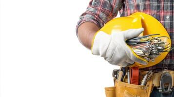 The worker holding a yellow hardhat and electrical wires in his hands. photo