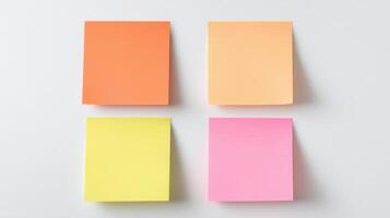 The colorful sticky notes arranged in a neat square layout on a table. photo