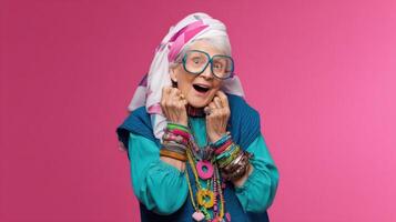 The joyful elderly woman expressing excitement with colorful accessories and playful style. photo