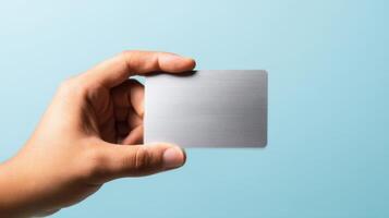 The elegant metal card held in a hand against a soft background photo