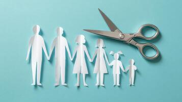 The paper cutout family holding hands with scissors on a blue background. photo