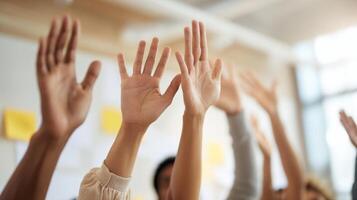 The hands of eager participants raised in a collaborative learning environment. photo