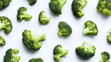 The fresh broccoli pieces scattered on a clean white background. photo