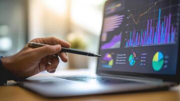 The laptop displaying financial analytics and graphs in a professional setting. photo