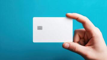 The blank card held by hand with a modern design on blue background. photo