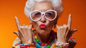 The vibrant elderly woman showcasing bold fashion and a playful spirit. photo