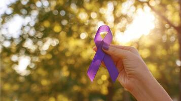 The purple ribbon symbolizing hope and awareness in nature's vibrant setting. photo