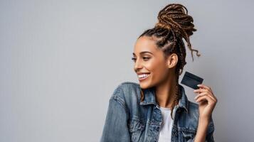 The woman with a credit card showcasing her joyful personality in a casual setting. photo