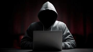 The mysterious figure working on a laptop in a dark, atmospheric setting. photo