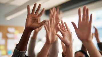 The hands of a diverse group demonstrating engagement and teamwork in a workplace setting. photo