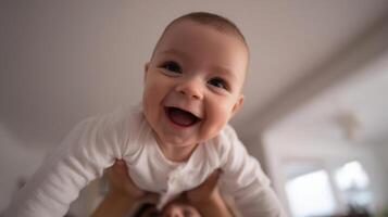 The joyful baby being playfully lifted by a caring parent in a cozy setting. photo
