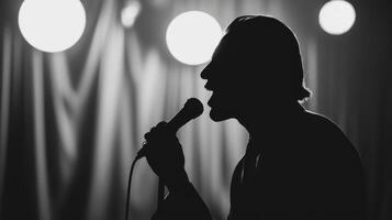 The silhouette of a passionate vocalist performing on stage under dramatic lighting. photo