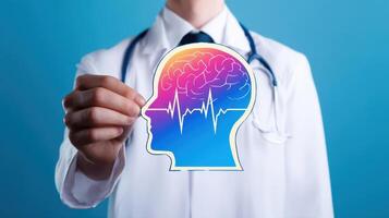 The healthcare professional holding a colorful brain illustration symbolizing mental health awareness. photo