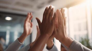 The hands of diverse colleagues celebrating collaboration and success in the workplace. photo