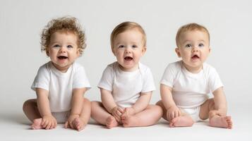The adorable trio of smiling babies in a bright, cheerful setting. photo