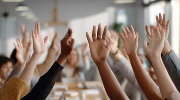 The hands of engaged participants raised during an interactive meeting session. photo