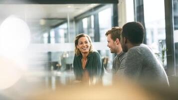 The engaged group enjoying a friendly conversation in a modern workspace photo