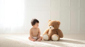 The adorable baby enjoying a moment with a fluffy teddy bear. photo