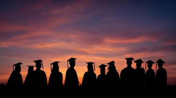 The silhouettes of graduates celebrating at sunset during their graduation ceremony. photo