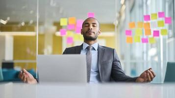The professional man meditating at his desk for improved focus and productivity. photo