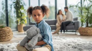 The sad girl holding her teddy bear in a cozy family setting. photo