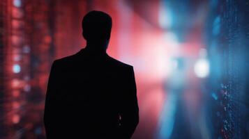 The silhouette of a man in a futuristic data corridor illuminated by colorful lights. photo
