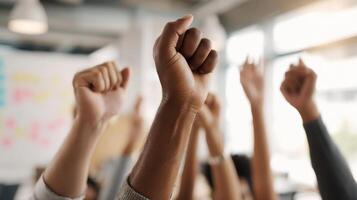 The raised hands symbolize unity and empowerment in a collaborative workspace. photo