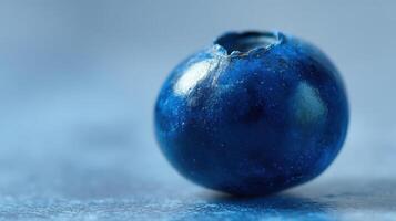 The close-up of a fresh blueberry showcasing its vibrant color and texture. photo