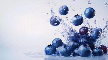 Blueberries are splashing into the water photo