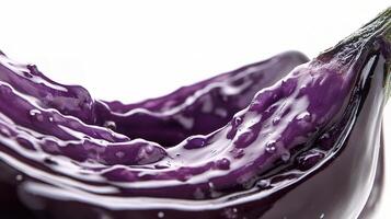 A purple eggplant with water droplets on it photo