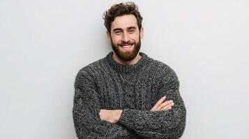 A man with a beard and sweater is smiling photo