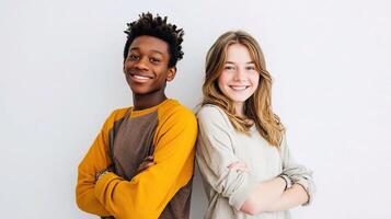 Two young people standing together against a white wall photo