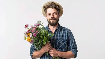 A man with a beard and hat holding a bunch of flowers photo