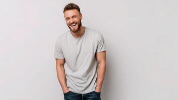 A man is smiling while standing in front of a white background photo
