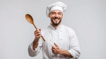 Chef holding wooden spoon and smiling photo