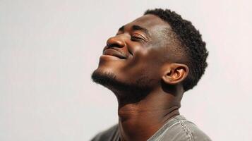 A man with his eyes closed looking up photo